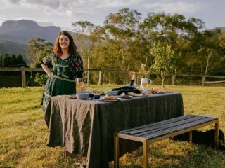 Woman standing next to a table of food